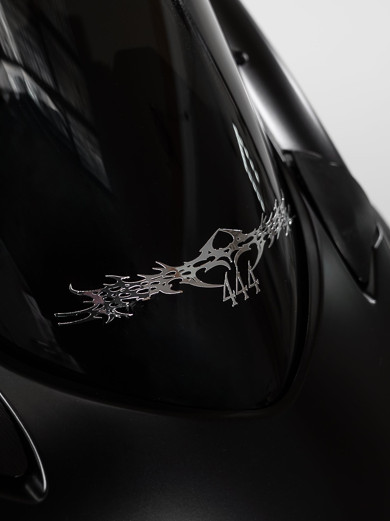 Close-up of a car emblem with a dark background